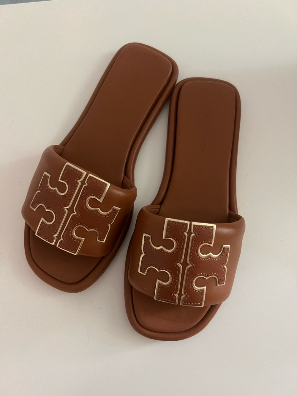 Tory Burch Double T Sport Slides in a brown leather with a gold metallic logo